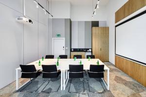 a meeting room with a table and chairs at Courtyard by Marriott Warsaw Airport in Warsaw
