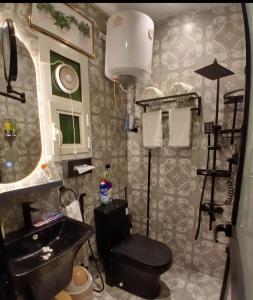 a bathroom with a sink and a toilet and a mirror at best rest apartments - 3 in Riyadh