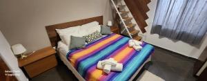 una camera da letto con un letto con una coperta colorata di Expò Suite a Genova