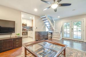 a living room with a ceiling fan and a staircase at Near Hiking and Golf Cozy Cottage in Morgan Hill! in Morgan Hill