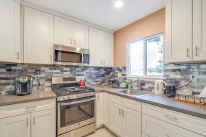 a kitchen with white cabinets and a stove top oven at Near Hiking and Golf Cozy Cottage in Morgan Hill! in Morgan Hill +16 photos