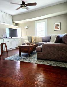 a living room with a couch and a coffee table at Charming Historic 2-story Carriage House located in Downtown Lakeland walking distance from FSC! in Lakeland