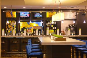 a bar in a restaurant with blue bar stools at Hotel Pentagon South in Alexandria +20 photos