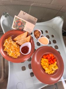 a tray with two bowls of food on a table at Vida Hostel in Medellín