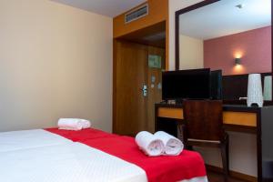 Katil atau katil-katil dalam bilik di Flag Hotel Barcelos