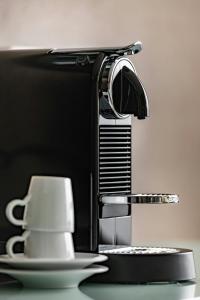 a coffee cup sitting next to a kitchen sink at Courtyard by Marriott Munich City Center in Munich