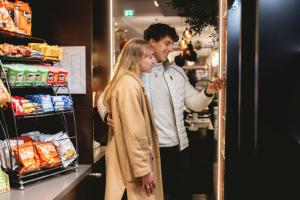 a man and a woman standing in a store aisle at Courtyard by Marriott Munich City Center in Munich