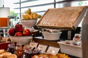 a buffet with bowls of fruit on a table at Courtyard by Marriott Munich City Center in Munich