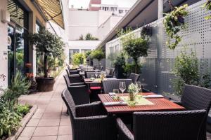 a row of tables and chairs on a patio at Courtyard by Marriott Munich City Center in Munich