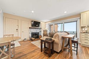 a living room with a couch and a table at New, condo stunning Lake View in Bellaire