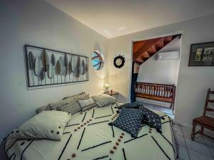 a bedroom with a large bed with pillows on it at KazaSunsetCat in Vieux-Habitants