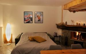 a bedroom with a bed with a fireplace and two posters at Pancino's House in Valtournenche
