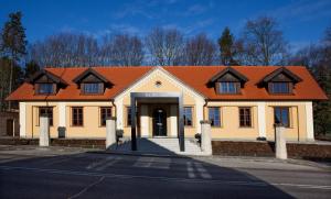 a building with an orange roof on a street at Hotel Koruna in Chlumec nad Cidlinou