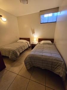 Postel nebo postele na pokoji v ubytování Amaru Peru Hotel