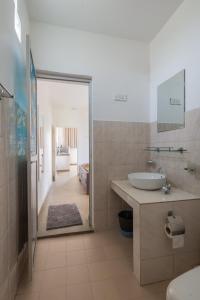 a bathroom with a sink and a mirror at The garden gate resort & Apartments No 02 in Negombo
