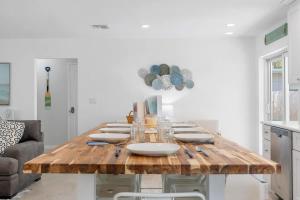 a dining room with a wooden table with plates on it at Heated Pool 5Mins to Beach 4Bed-2Bath King Bed in Largo +34 photos