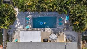 an overhead view of a swimming pool with trees at Heated Pool 5Mins to Beach 4Bed-2Bath King Bed in Largo