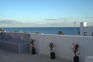 a view of the ocean from a balcony with plants at Dar Sonia in Hammamet +14 photos