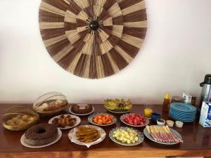 a table with many different types of food on it at Pousada Iyalodê in Marau
