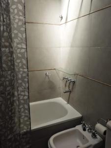 a bathroom with a sink and a shower and a toilet at CASA del PEZ céntrica para 5 huespedes in La Plata