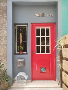 a red door on a house with a window at CASA del PEZ céntrica para 5 huespedes in La Plata