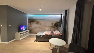a bedroom with a bed and a view of a beach at Apartament Pogodny in Chojnice