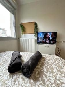 a bedroom with a bed with two pillows on it at Charmant studio à 20min de Paris in Créteil