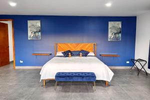a blue bedroom with a large bed with a blue wall at CASA LUGO mx in El Porvenir