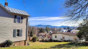 a house in a small town with mountains in the background at Moroccan Pearl Luray VA in Luray