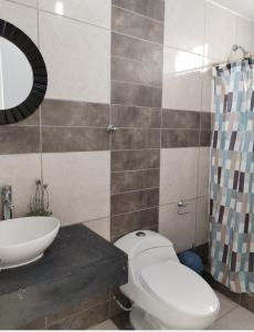 a bathroom with a toilet and a sink and a mirror at Duplex con piscina en Asia in Asia