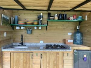 a kitchen with a sink and a stove at Ecolodge Finca Lalu in Santa Rosa de Cabal