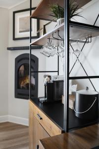 a kitchen with a counter with a stove and a fireplace at Anderson Inn in Morro Bay +36 photos
