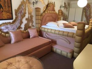 a bedroom with a bed and a couch at Bali Colosseum Hotel in Belgrade +47 photos