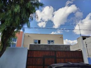 a house with a gate and a fence at Casa Lanre in Huichapan