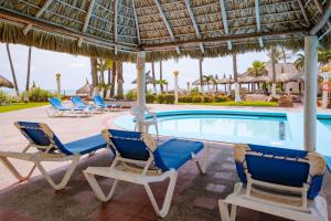 a pool with two lounge chairs and a swimming pool at Casa Lily in Mazatlán