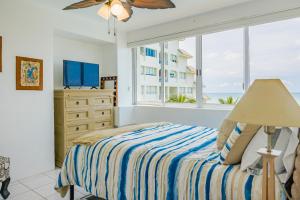 a bedroom with a bed and a large window at Casa Lily in Mazatlán +16 photos