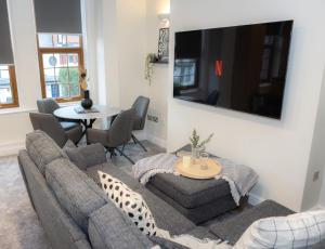 a living room with a couch and a table at Lethbridge Villa 49 Apartment 2 Super Fibre WiFi, free parking in Southport
