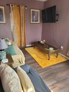 a living room with a couch and a coffee table at Tower Of Little Italy in Niagara Falls