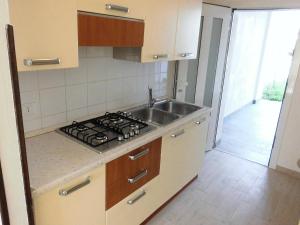 a kitchen with a sink and a stove at Cozy villa with private garden-Beahost in Porto Santa Margherita di Caorle +13 photos