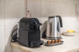 a coffee maker sitting on a counter in a kitchen at Spacious 2BDs Apt With Acropolis View In Center in Athens