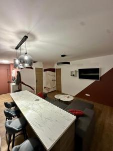 a living room with a couch and a table at Panorama Deluxe in Rosny-sous-Bois +4 photos