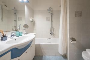a bathroom with a sink and a bath tub at Spacious 2BDs Apt With Acropolis View In Center in Athens