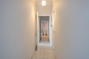 a hallway with white walls and a hallway with two doors at Spacious 2BDs Apt With Acropolis View In Center in Athens