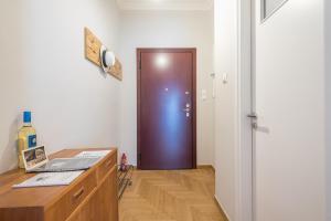 a room with a door and a desk with a laptop at Spacious 2BDs Apt With Acropolis View In Center in Athens