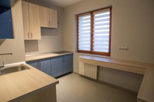 a kitchen with a sink and a window in it at Luxe Stay in Târgu-Mureş