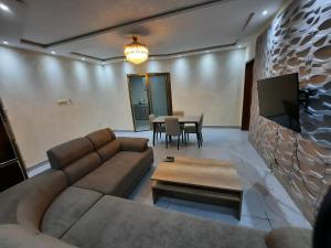 a living room with a couch and a table at Elira 2 chambres rez-de-chaussée in Kinshasa