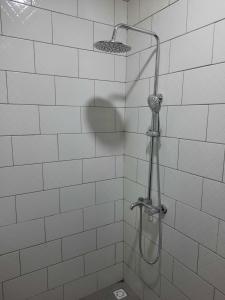 a shower with a shower head in a bathroom at Elira 2 chambres rez-de-chaussée in Kinshasa +23 photos