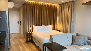 a hotel room with a bed and a couch at White 2880 - Pinheiros in Sao Paulo +39 photos