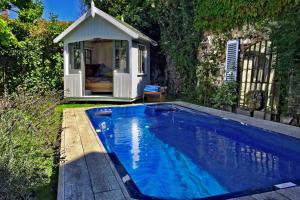 a swimming pool with a gazebo in a yard at Maison-76 in Montreuil-sur-Mer