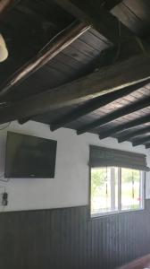 a room with a flat screen tv and a window at cabaña las casuarinas in San Clemente del Tuyú